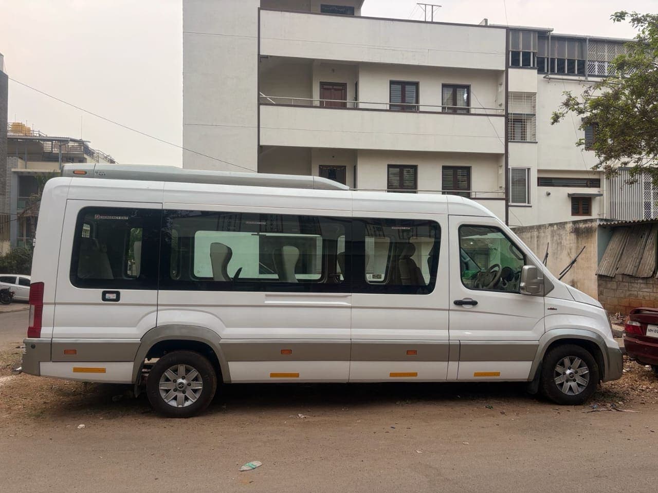 A tempo traveller van parked on a group outstation trip