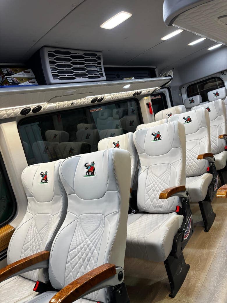 Comfortable reclining seats inside a tempo traveller used on a group trip