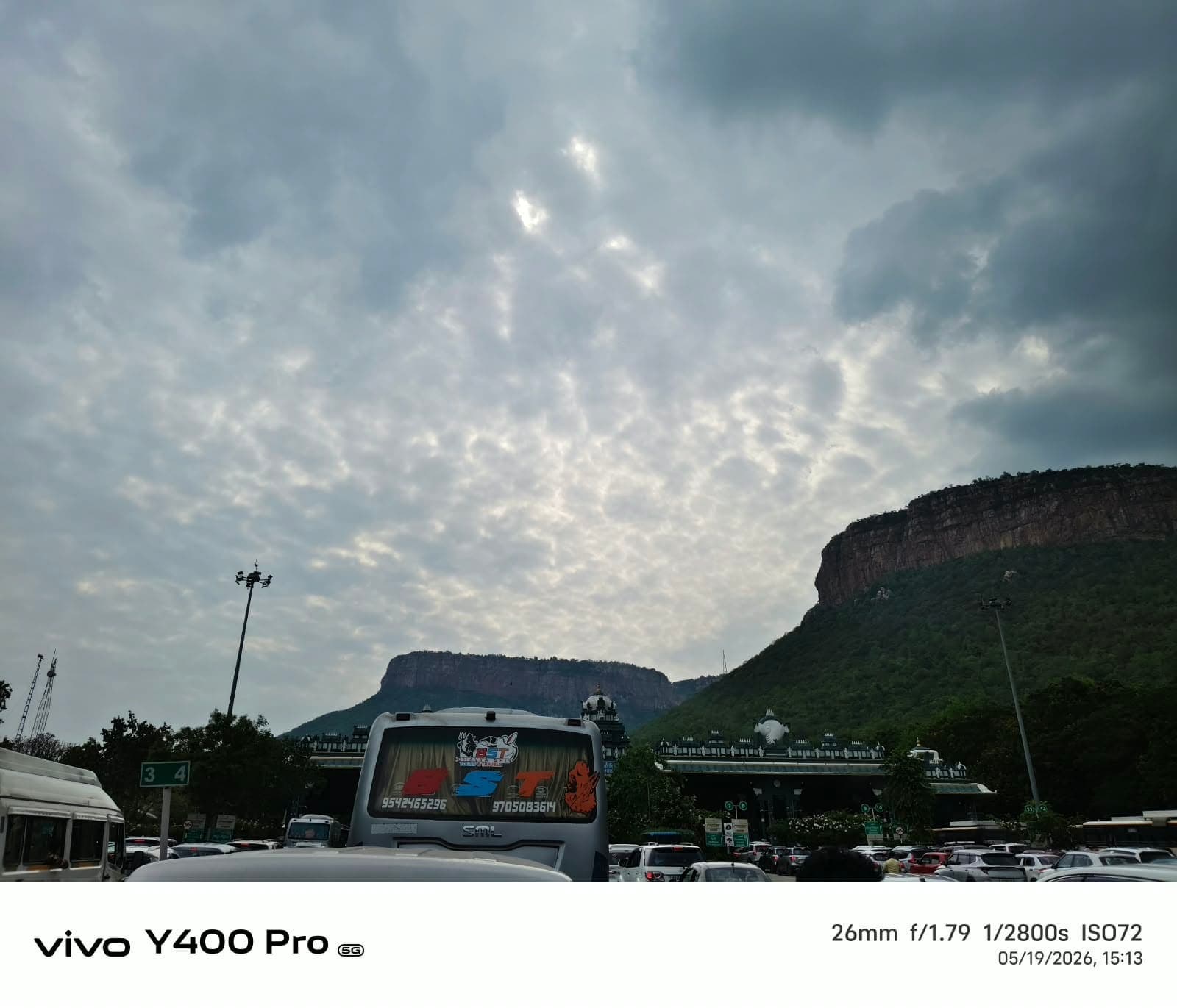Buses and vehicles at the base of the Tirupati temple hills during a pilgrimage trip