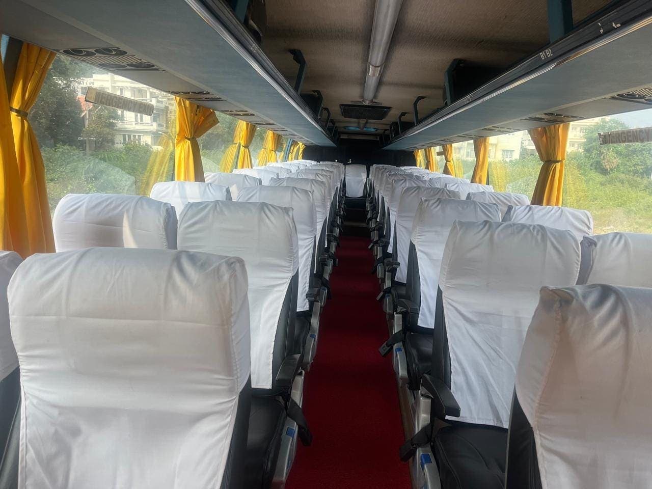 Rows of covered seats inside a tourist coach used for a group trip